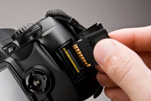 inserting a memory card into a modern DSLR camera